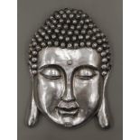 A silver coloured Buddha mask wall plaque. 56 cm high.