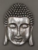 A silver coloured Buddha mask wall plaque. 56 cm high.