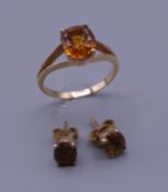 An 18 ct gold stone set ring with matching earrings. Ring size S/T. 6.5 grammes total weight.