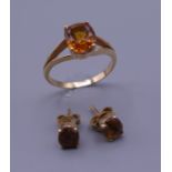 An 18 ct gold stone set ring with matching earrings. Ring size S/T. 6.5 grammes total weight.