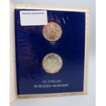 A pair of Vatican silver coins (1000 and 500 Lira coins).