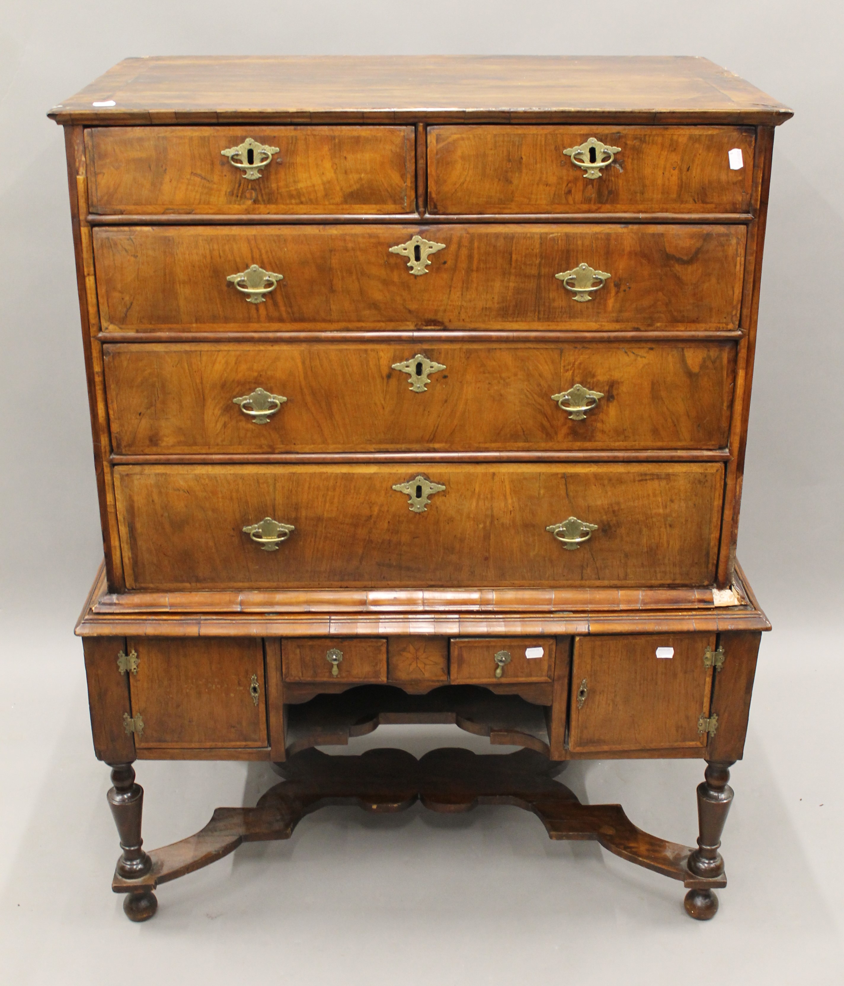 An 18th century walnut chest on stand. 101 cm wide x 129.5 cm high.