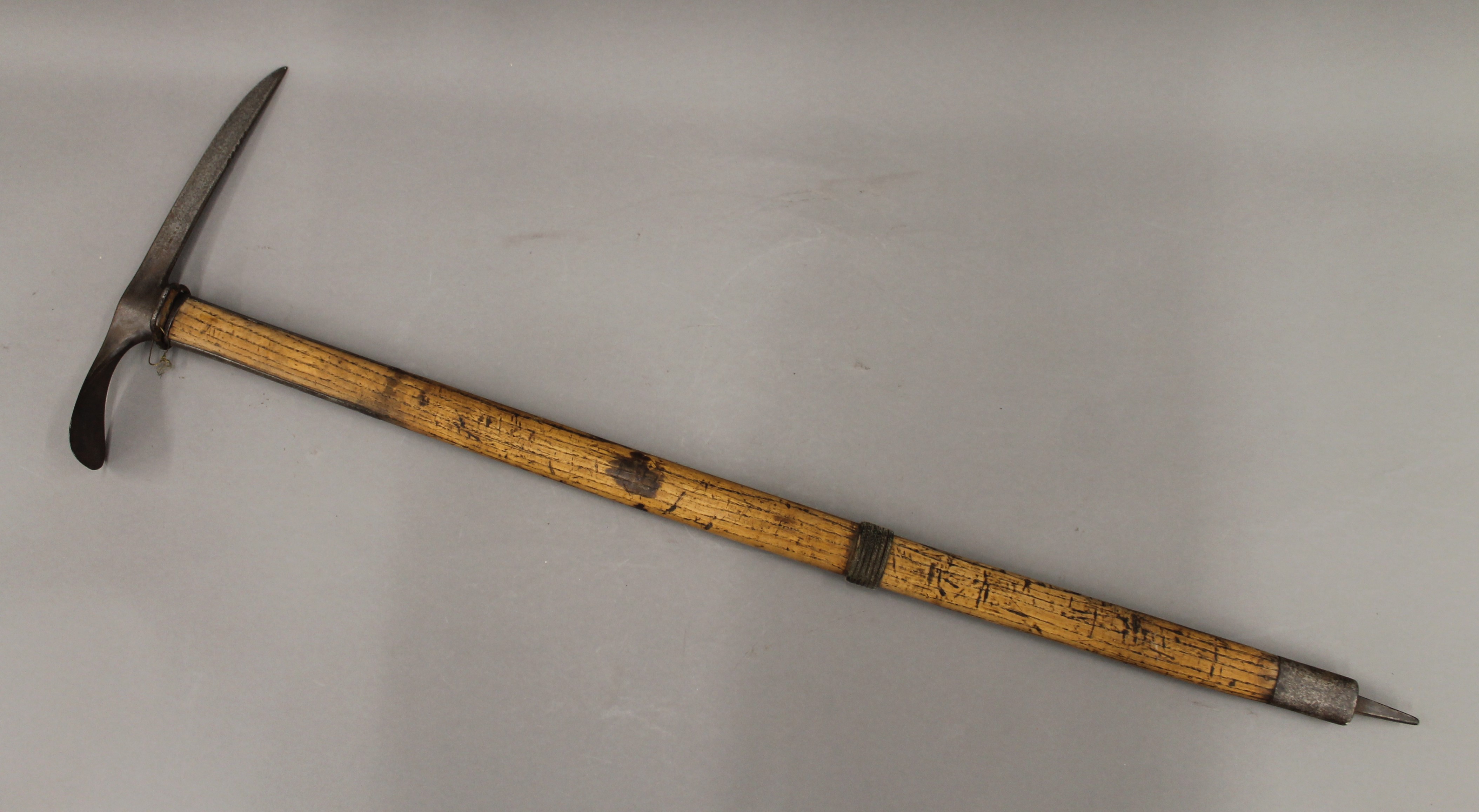 A vintage mountaineering ice axe. 90 cm long.