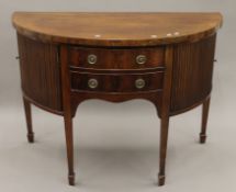 A George III mahogany demi lune sideboard. 137 cm wide.