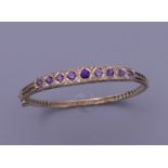 An Edwardian 9 ct gold bangle set with diamonds and amethyst. 13.4 grammes total weight. 5.