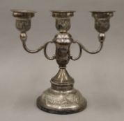 A sterling silver candelabra decorated with elephants. 20.5 cm high. 644.2 grammes total weight.
