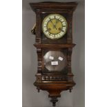 A 19th century walnut wall clock. 58 cm high.