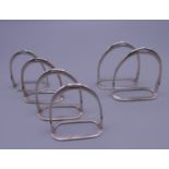 Six stirrup napkin holders. Four 4.5 cm high x 4 cm wide, two 5 cm high x 4.75 cm wide.