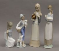 Two Lladro figurines and two other similar figurines. The largest 27 cm high.