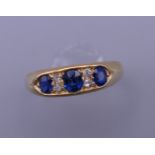 An 18 ct gold diamond and sapphire ring. 5.3 grammes total weight.