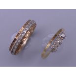 An 18 ct gold and platinum three stone ring (2 grammes total weight) and a gold eternity ring (3.