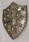 An Eastern antique spiked shield. 58 cm high.