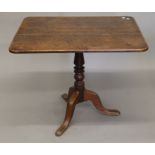 A George III oak tilt top tripod table. The top 86 x 67 cm.
