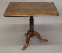 A George III oak tilt top tripod table. The top 86 x 67 cm.