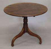 A George III mahogany tilt top tripod table. 82 cm diameter.