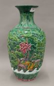 A Chinese green ground pottery vase. 35 cm high.