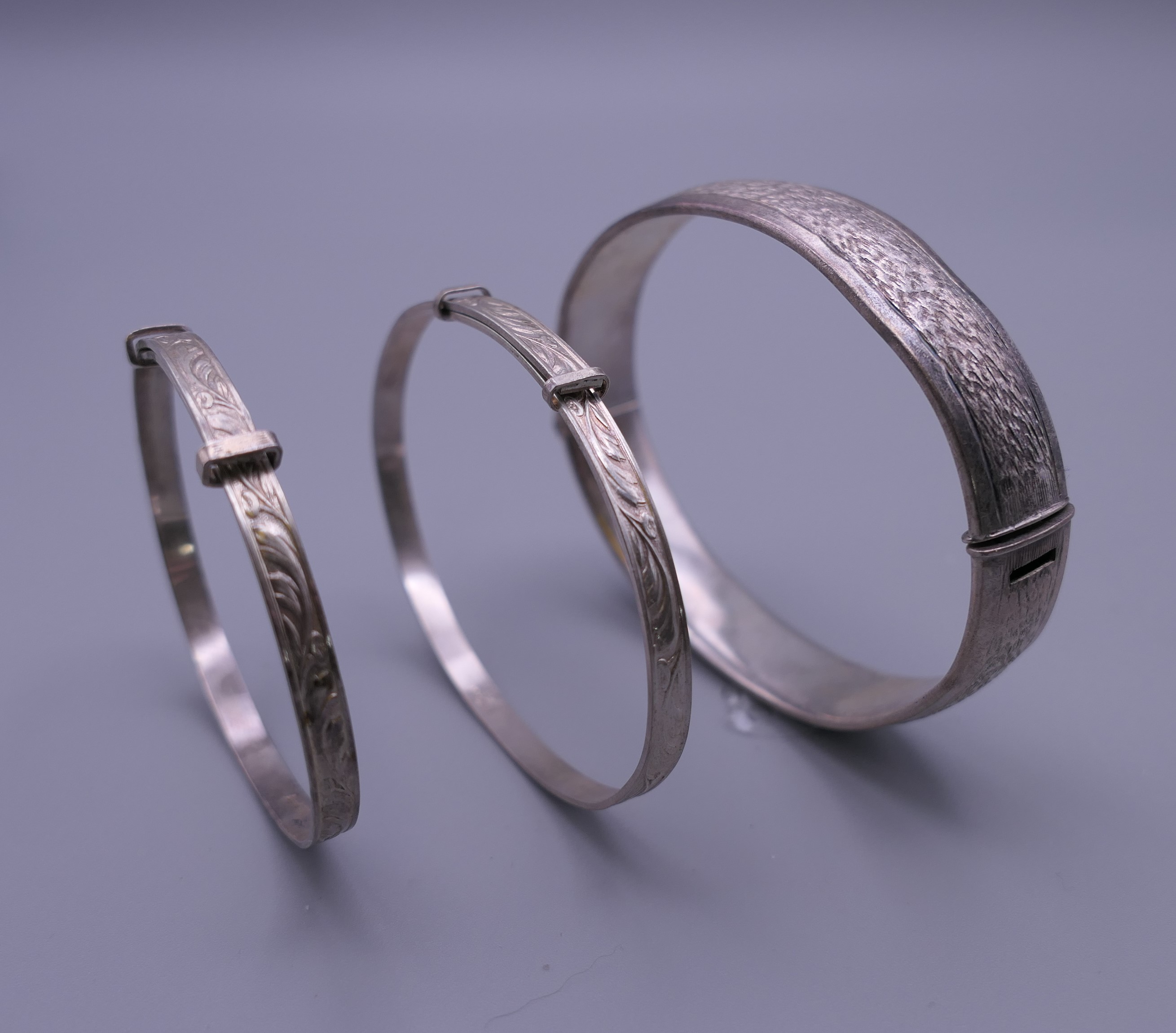 Three silver Christening bangles. The largest 6.5 cm diameter. 37.7 grammes.