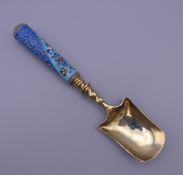 A silver enamel caddy spoon, bearing Russian marks. 16.5 cm long.