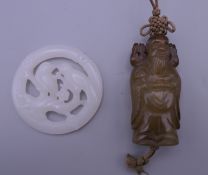 A white jade bird pendant and a jade god pendant. Bird pendant 5.