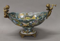 A bronze and porcelain cherub centrepiece. 30 cm wide.
