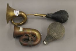 Two vintage brass car horns.