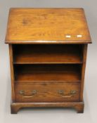 A modern oak bedside cupboard and cane back chair. The former 48 cm wide.