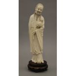 A 19th century Chinese carved ivory figure mounted on a wood metal inlaid wooden stand.