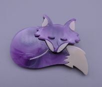 A Lea Stein style brooch formed as a sleeping fox. 6 cm x 4.5 cm.