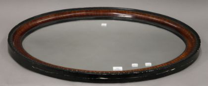 An early 20th century oval mirror. 85 cm wide.