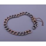 A silver and gold bracelet. 20 cm long. 16.2 grammes total weight.