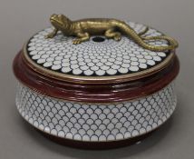 A porcelain and bronze lidded box. 13 cm diameter.