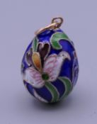 A Russian silver and enamel egg pendant. 2.5 cm high.