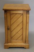 An Arts and Crafts inlaid ash pot cupboard, en-suite (see also the previous two lots).