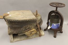A set of antique foot bellows and a cast iron juicing press. The former 55 cm long.
