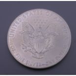 A 2015 US fine silver 1 ounce dollar.