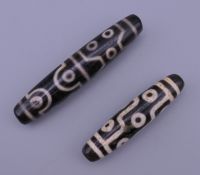 Two agate zhi beads. 7.5 cm long and 5.75 cm long.