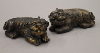 A pair of Chinese gilt bronze recumbent temple lions. 13 cm long.