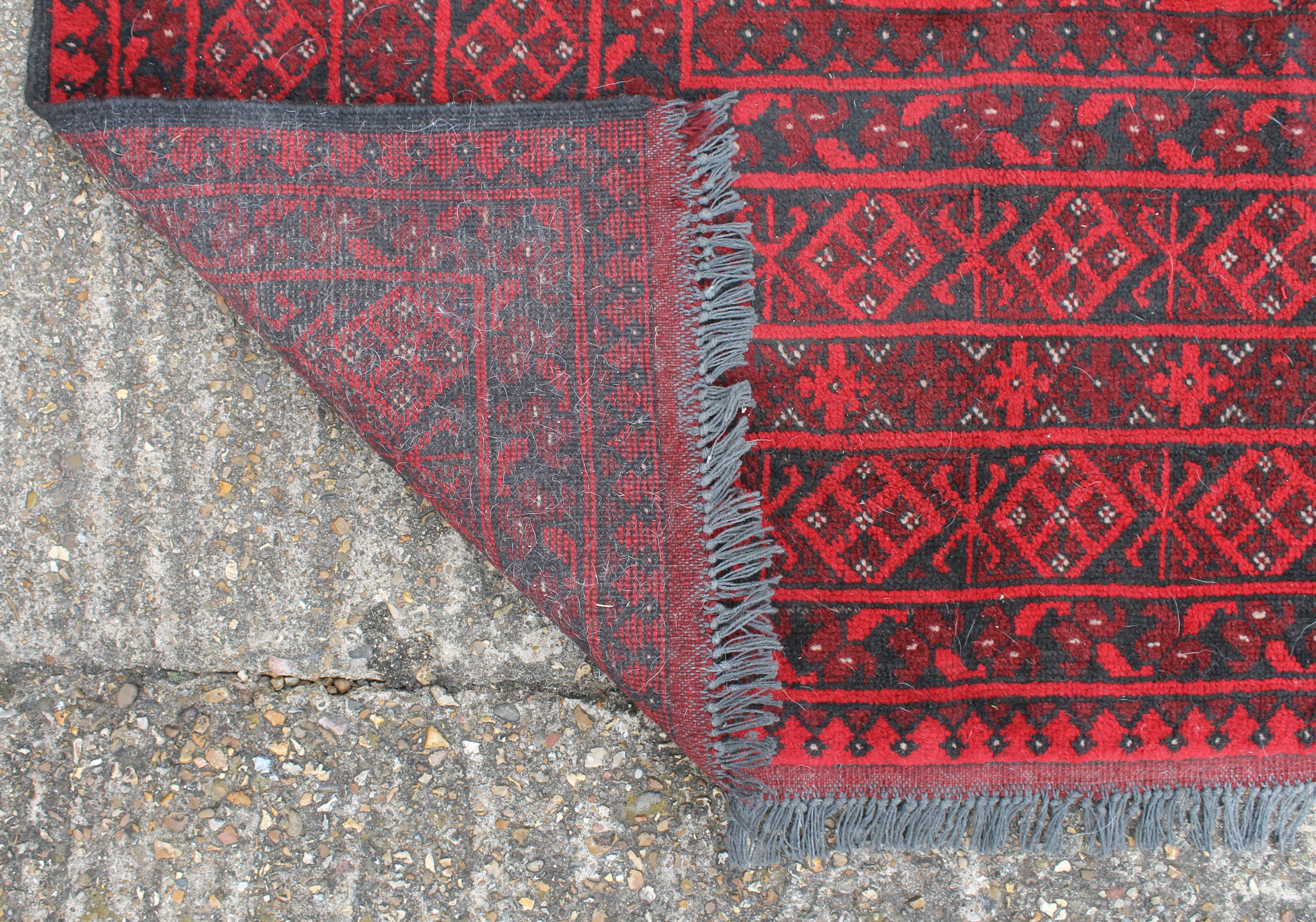 A red ground Balouch rug. 288 x 195 cm. - Image 3 of 3