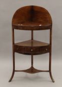 A George III mahogany corner washstand. 57 cm wide.