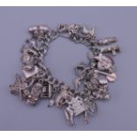 A silver charm bracelet. 20 cm long. 87 grammes total weight.