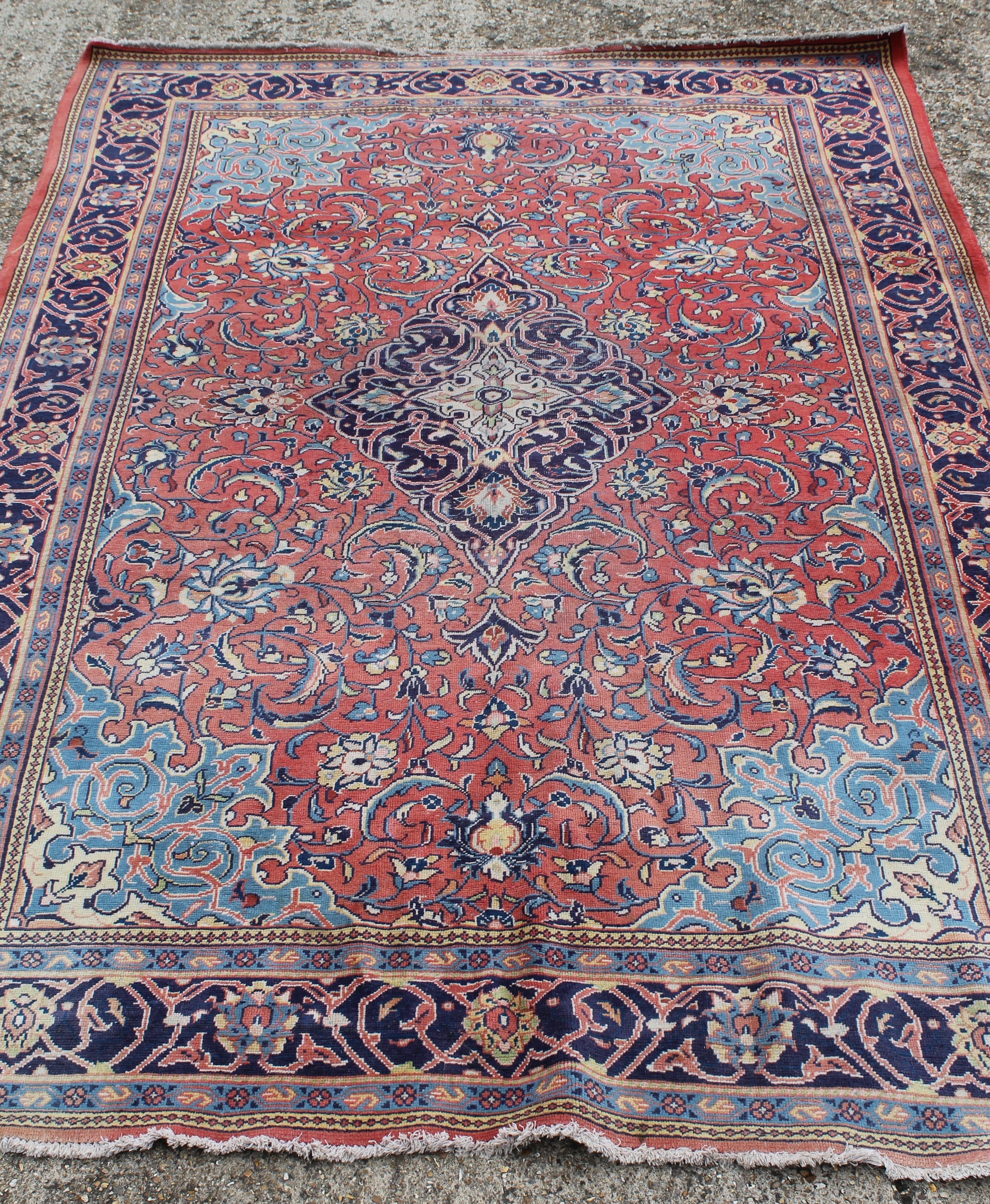 A large Iranian red ground wool rug. 330 x 222 cm.