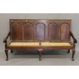 An 18th century oak panelled back settle.