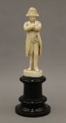 A 19th century Dieppe carved ivory model of Napoleon Bonaparte mounted on an ebonised wooden plinth