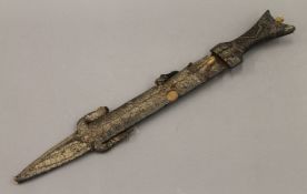 An Eastern dagger in a lizard skin sheath. 52.5 cm long.