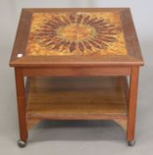 A 20th century tiled top coffee table. 52 cm wide.