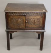 A 20th century carved oak two door side cabinet. 71 cm wide, 77.5 cm high, 47.5 cm deep.