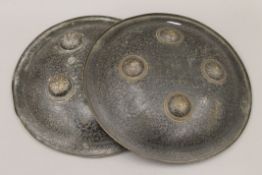 A pair of 19th century Indian dhal shields. Each 28.5 cm diameter.