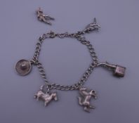 A small silver charm bracelet. 18.5 cm long. 19.7 grammes.