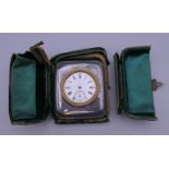 A silver cased travel clock. Case 6.5 cm x 7.5 cm.