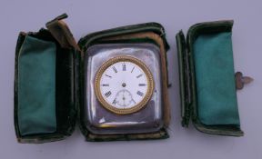 A silver cased travel clock. Case 6.5 cm x 7.5 cm.